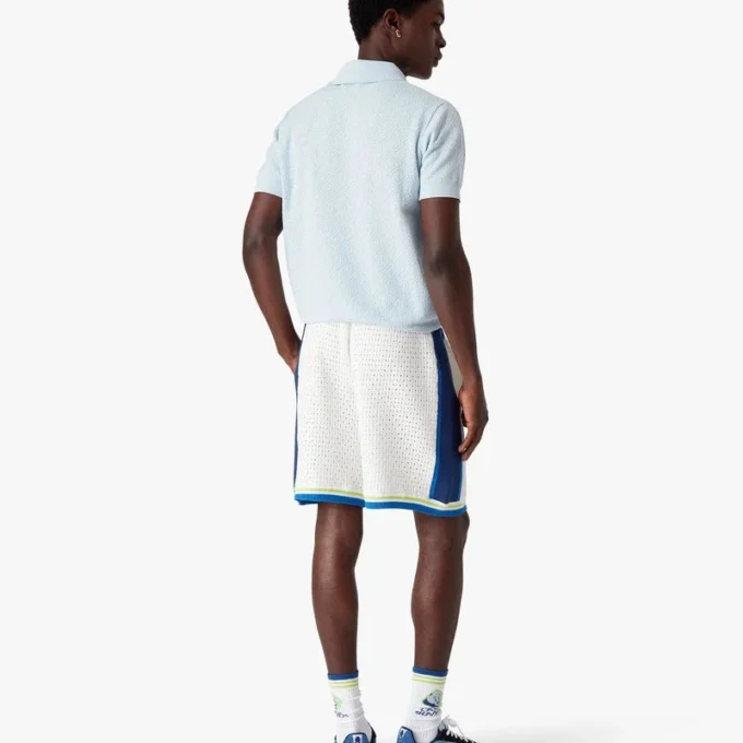 Polo a maniche corte con monogramma blu a punto traforato in pantaloncini